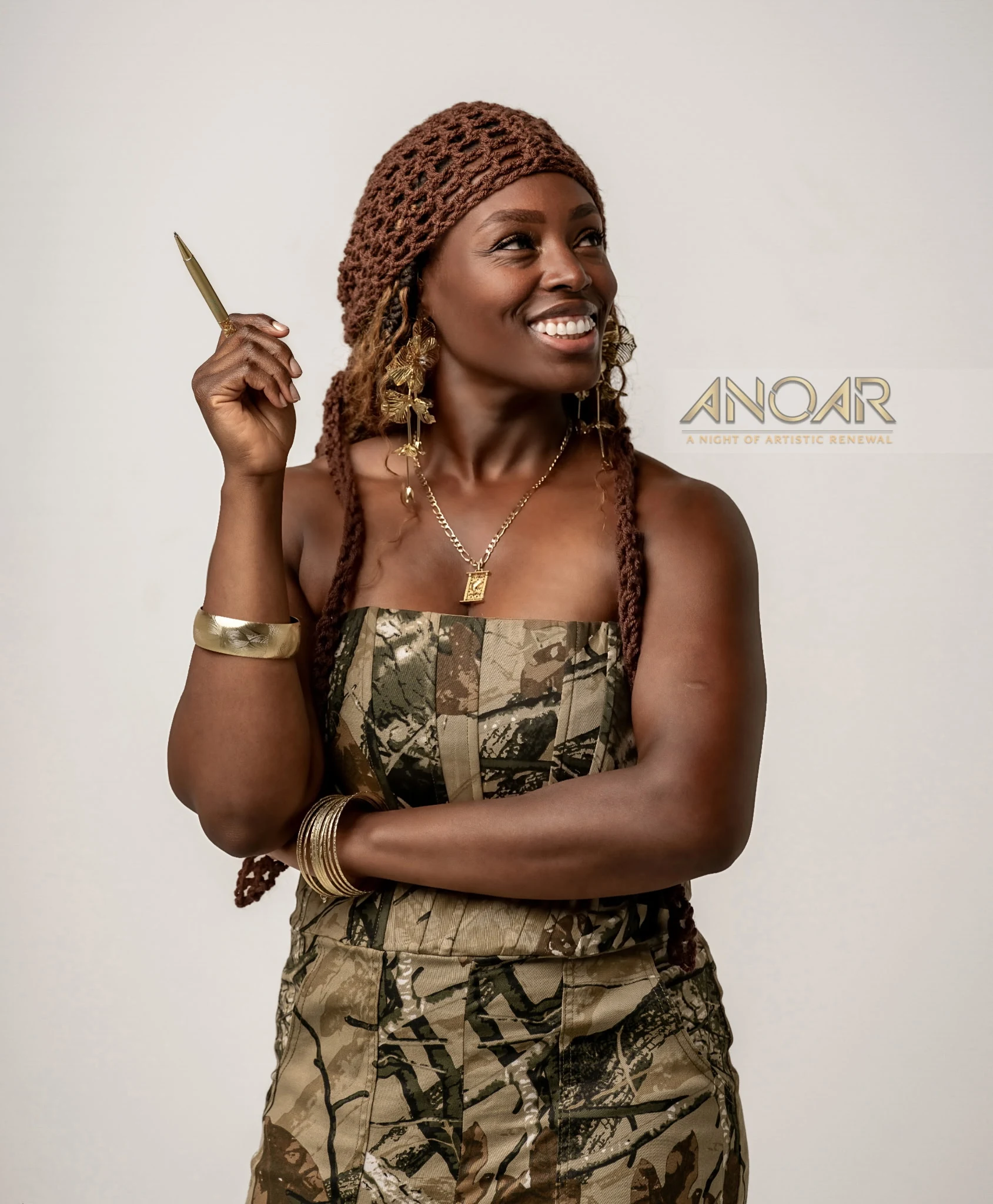 Linda Orji smiling with a gold pen for A Night of Artistic Renewal