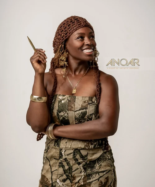 Linda Orji smiling with a gold pen for A Night of Artistic Renewal