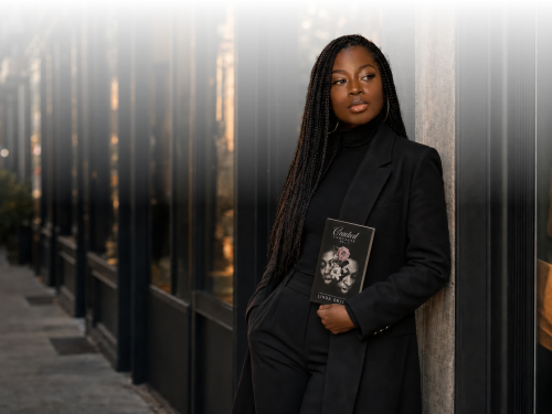 Linda Orji holding Cracked Concrete Volume I on a New York City street