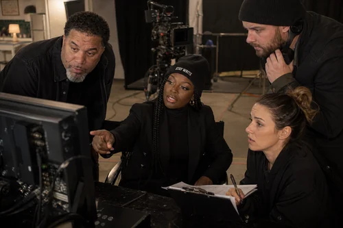 Linda Orji guiding Matthew Marrow and a production team at video village