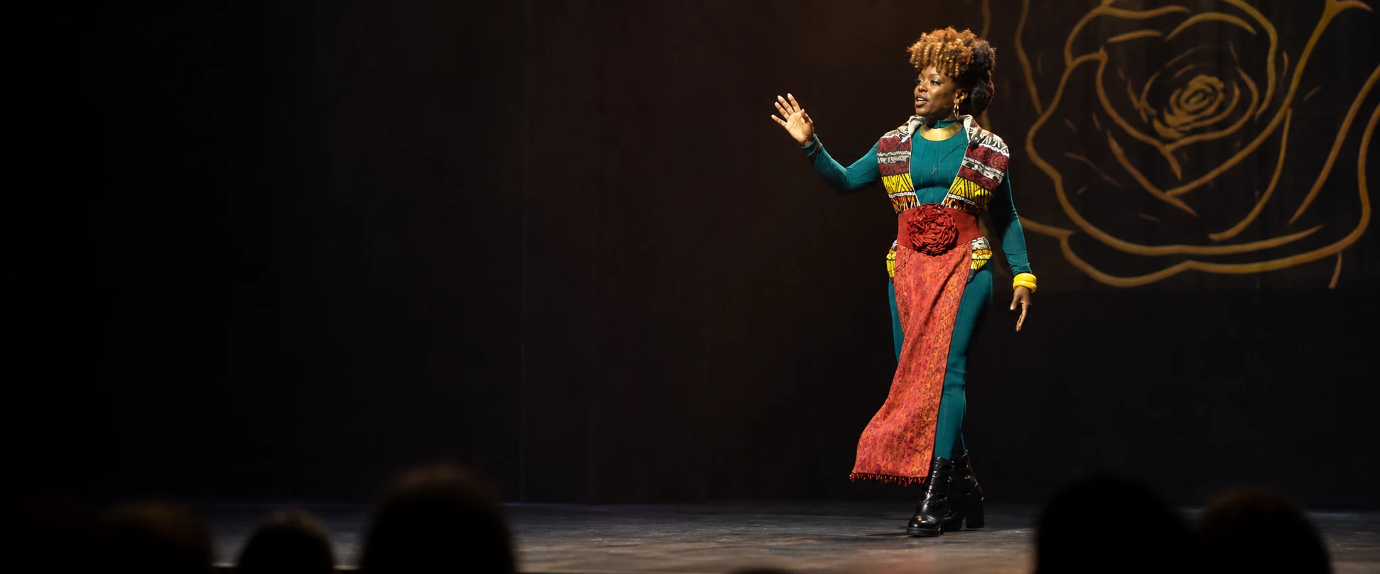 Linda Orji commanding the stage during A Night of Artistic Renewal as the audience watches