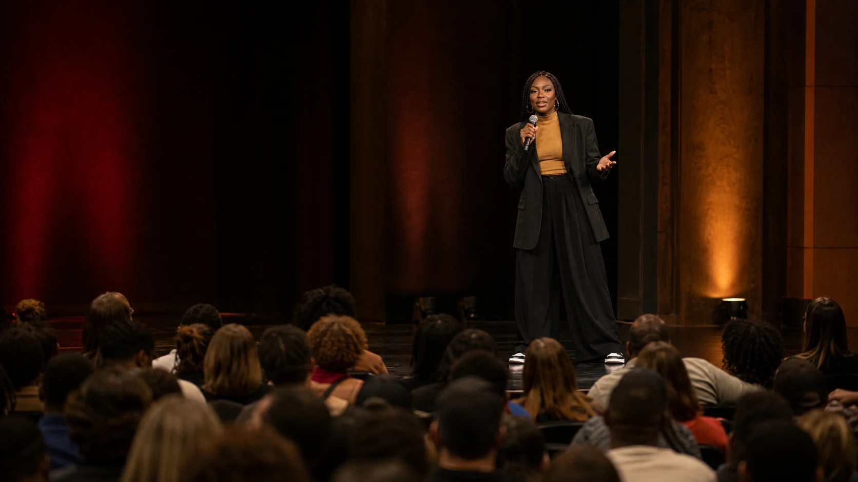 Linda Orji speaking to a full college auditorium audience