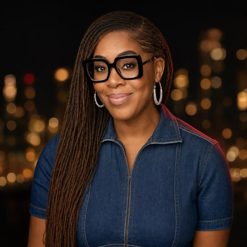 Black and white portrait of Linda Orji seated in a library